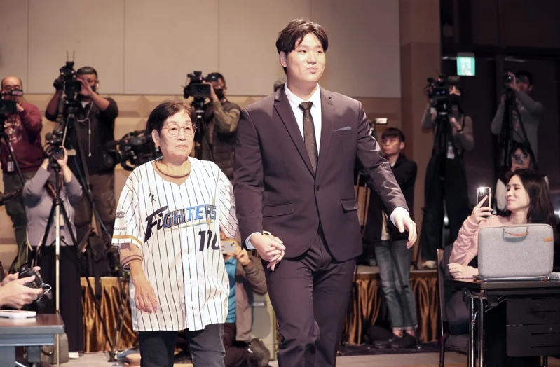 古林睿煬牽著從小帶他長大的阿嬤進場